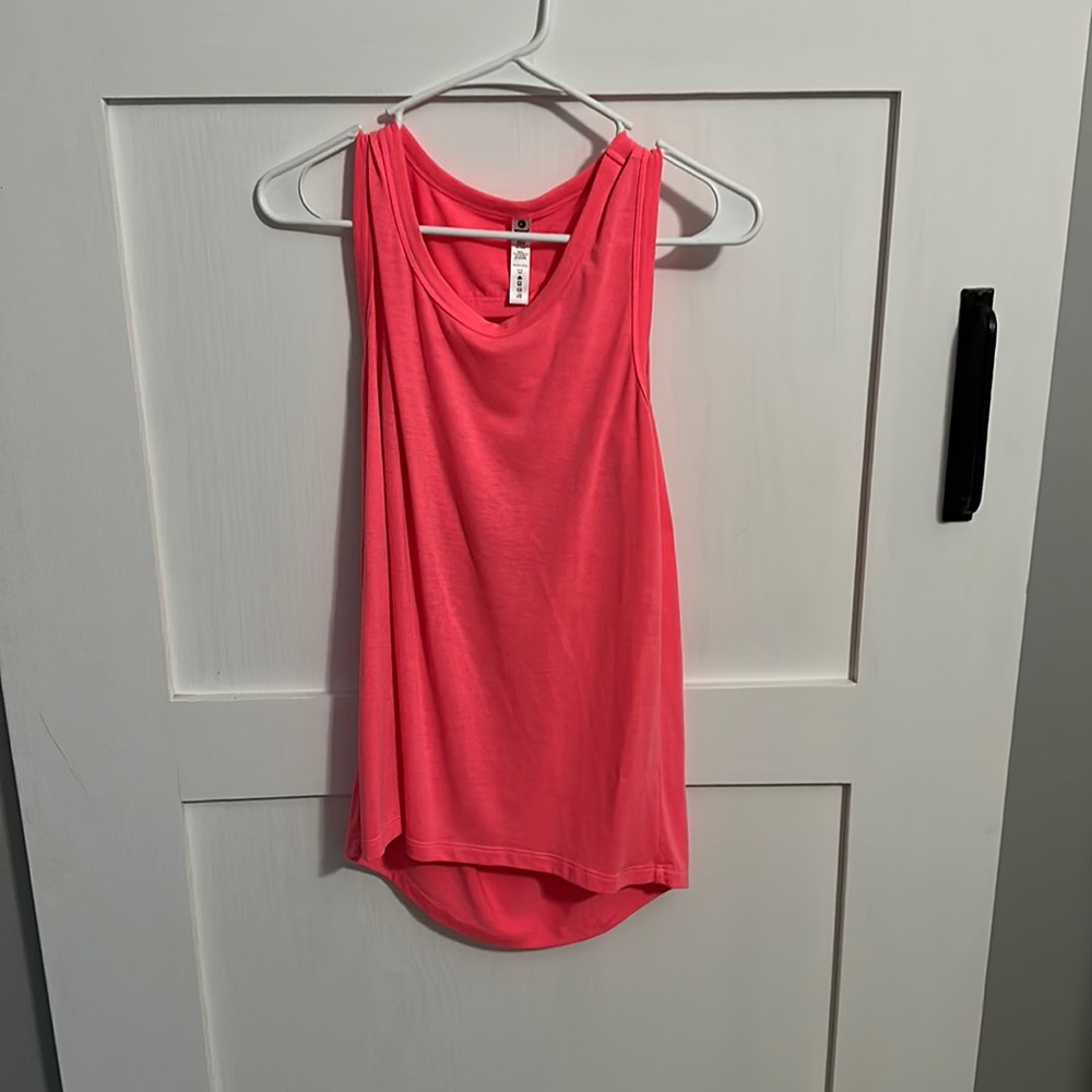 Pink, flowy yoga tank top with cut out in the back. Size small.